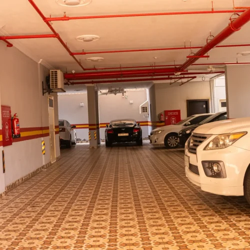 Covered parking garage with cars, Best Trip Paris