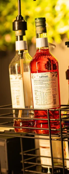Beverage station with syrup bottles and dispensers