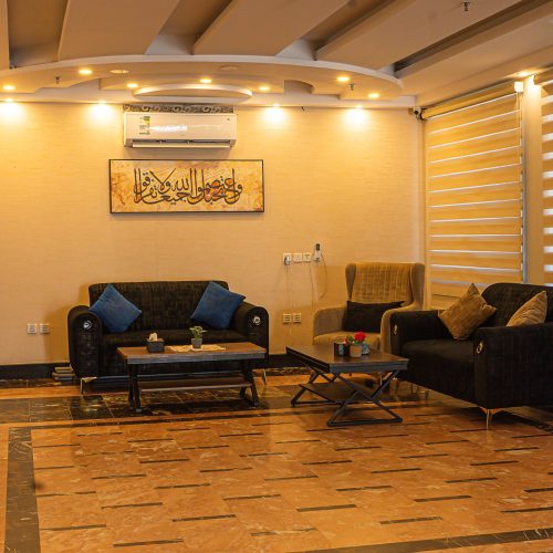 Hotel lounge with sofas, coffee tables and calligraphy wall art, Best Trip Hotels