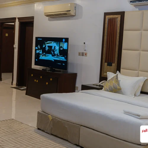 Hotel bedroom with TV and padded headboard wall, Al Andalus Tolen Hotel